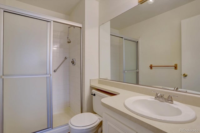 full bath with vanity, toilet, and a shower stall