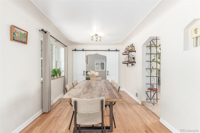 3865 Independence Ct, Wheat Ridge, CO 80033 - dining area with baseboards, light wood-type flooring, a barn door, and visible vents