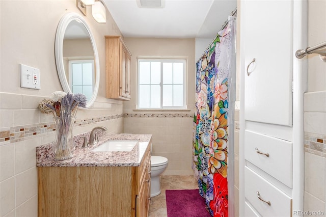 3865 Independence Ct, Wheat Ridge, CO 80033 - bathroom with visible vents, tile walls, vanity, toilet, and a shower with shower curtain