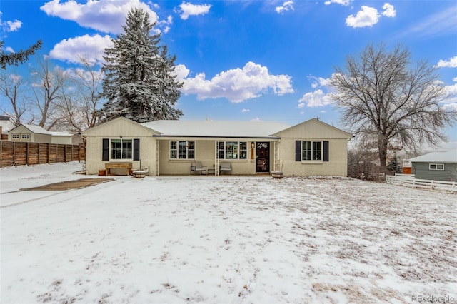 3865 Independence Ct, Wheat Ridge, CO 80033 - snow covered house featuring brick siding and fence