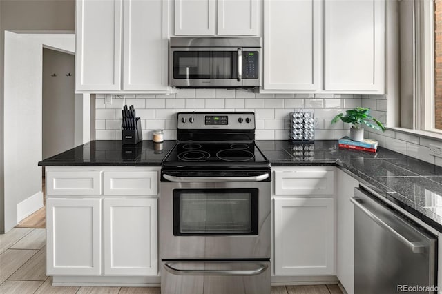 kitchen with white cabinetry and appliances with stainless steel finishes