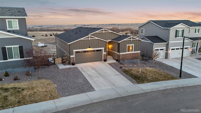 view of front facade featuring driveway, a garage, and board and batten siding