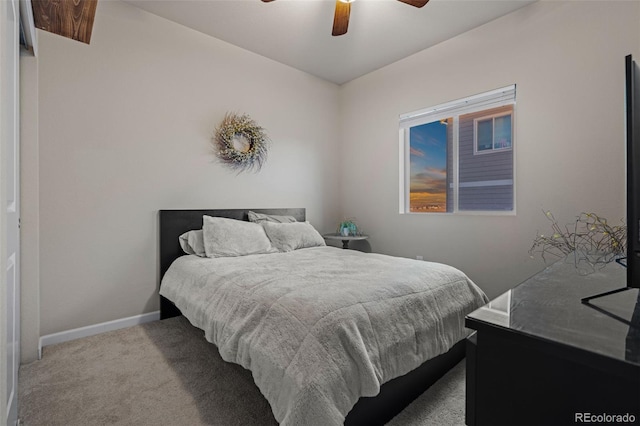 carpeted bedroom featuring ceiling fan and baseboards