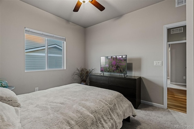 bedroom with a ceiling fan, carpet, visible vents, and baseboards