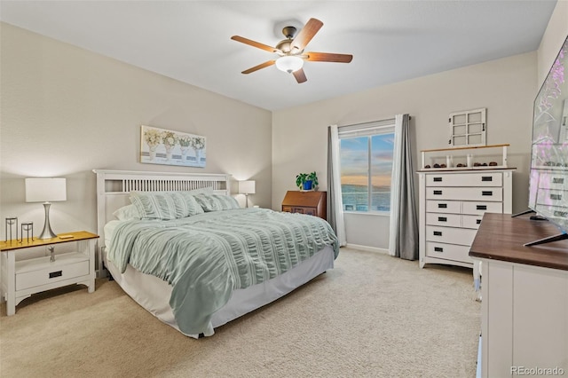 bedroom featuring a ceiling fan, light carpet, and baseboards