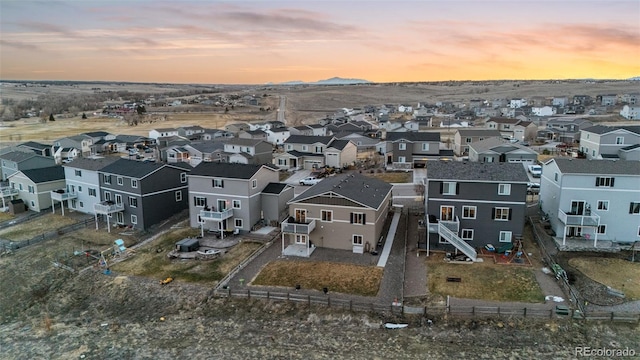 aerial view at dusk featuring a residential view