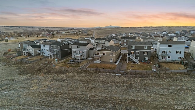 aerial view at dusk featuring a residential view