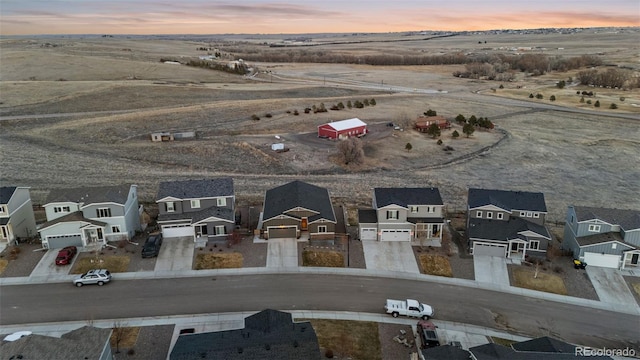 aerial view at dusk featuring a residential view