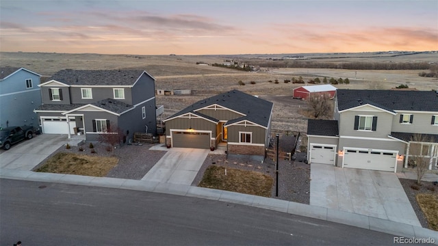 traditional-style home with driveway, a garage, and board and batten siding