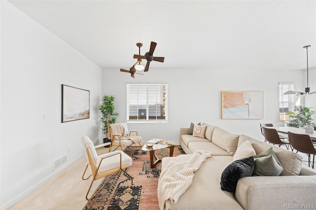 living room featuring ceiling fan and carpet flooring