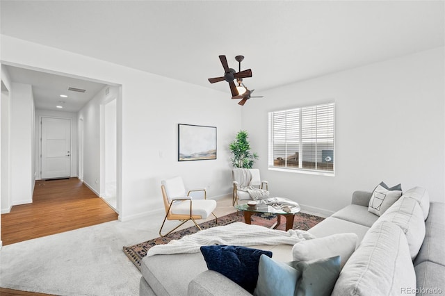 living room with ceiling fan and carpet