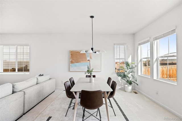 dining area with light colored carpet