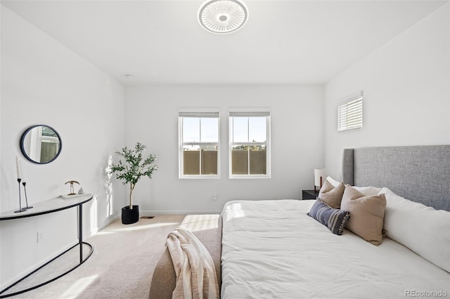 bedroom with light colored carpet