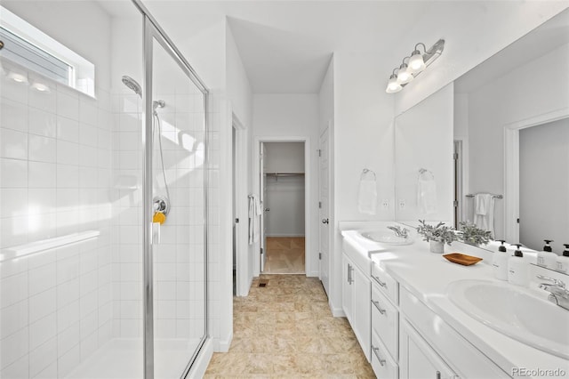 bathroom featuring vanity and a shower with door