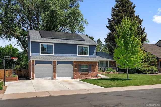 3767 E Phillips Cir, Centennial, CO 80122 - view of front of house with brick siding, a garage, roof mounted solar panels, driveway, and roof with shingles