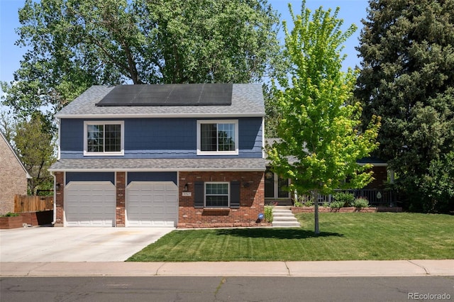 3767 E Phillips Cir, Centennial, CO 80122 - view of front facade featuring concrete driveway, an attached garage, brick siding, and roof mounted solar panels