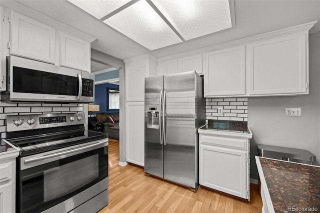 3767 E Phillips Cir, Centennial, CO 80122 - kitchen with appliances with stainless steel finishes, light wood finished floors, white cabinetry, decorative backsplash, and dark countertops