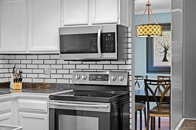 3767 E Phillips Cir, Centennial, CO 80122 - kitchen with appliances with stainless steel finishes, white cabinetry, dark countertops, tasteful backsplash, and crown molding
