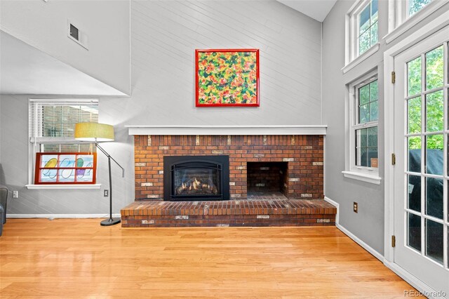 3767 E Phillips Cir, Centennial, CO 80122 - unfurnished living room featuring a high ceiling, baseboards, wood finished floors, and a fireplace