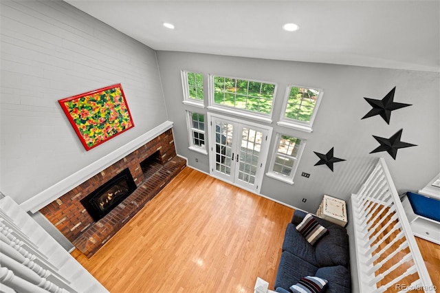 3767 E Phillips Cir, Centennial, CO 80122 - living area featuring a brick fireplace, light wood-type flooring, french doors, and recessed lighting