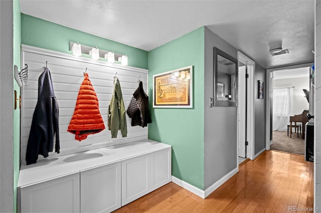 3767 E Phillips Cir, Centennial, CO 80122 - mudroom featuring light wood finished floors, baseboards, and a textured ceiling