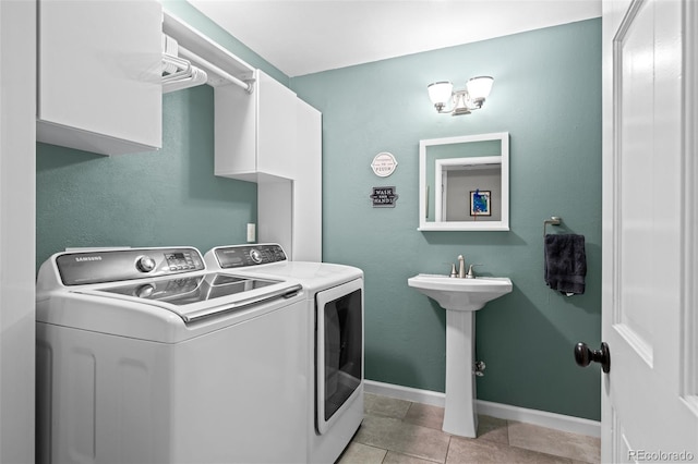 3767 E Phillips Cir, Centennial, CO 80122 - laundry room featuring independent washer and dryer, cabinet space, light tile patterned floors, and baseboards