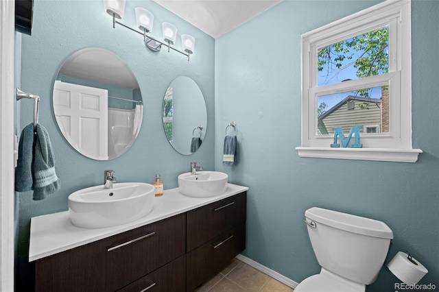 3767 E Phillips Cir, Centennial, CO 80122 - bathroom with tile patterned floors, toilet, double vanity, baseboards, and a shower with curtain