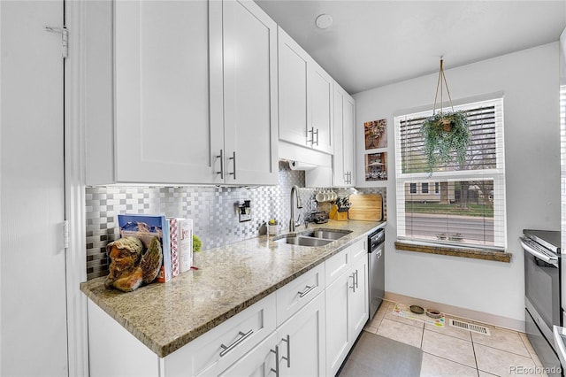 kitchen with a sink, appliances with stainless steel finishes, decorative backsplash, and white cabinetry