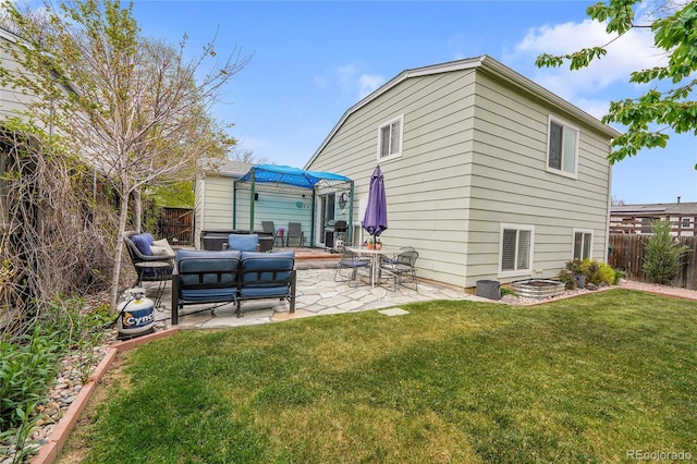 rear view of property with a patio and an outdoor living space