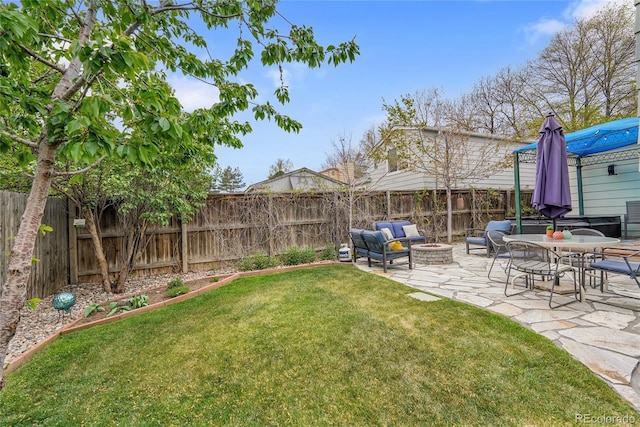 view of yard featuring a fire pit and a patio area