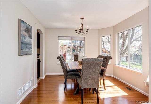 dining space with visible vents, plenty of natural light, and an inviting chandelier