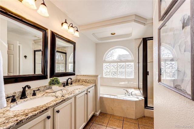 full bath featuring tile patterned flooring, a sink, a bath, and a stall shower