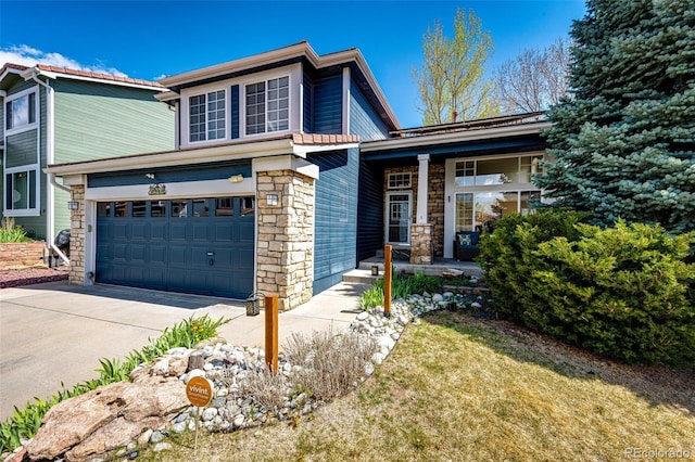 traditional home with an attached garage, driveway, and stone siding