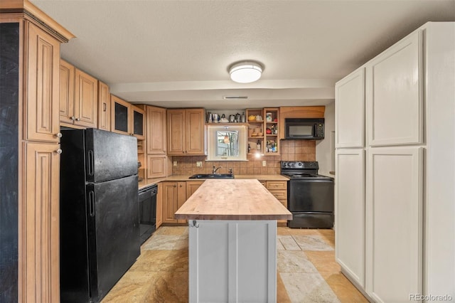 2041 Virginia St, Idaho Springs, CO 80452 - kitchen with glass insert cabinets, butcher block counters, a sink, backsplash, and black appliances