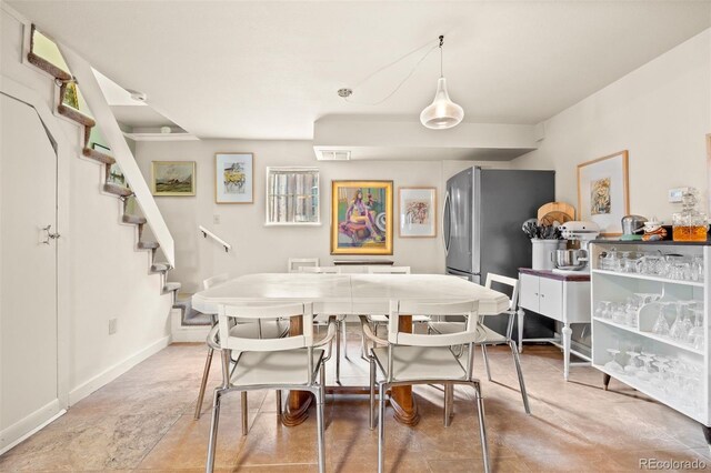 2041 Virginia St, Idaho Springs, CO 80452 - dining space with visible vents, baseboards, and stairway