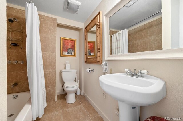 2041 Virginia St, Idaho Springs, CO 80452 - bathroom featuring toilet, shower / tub combo with curtain, visible vents, a sink, and tile patterned flooring