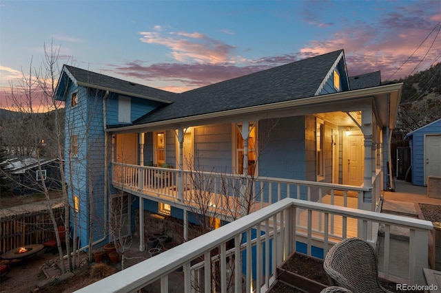 2041 Virginia St, Idaho Springs, CO 80452 - rear view of house with a storage shed, a shingled roof, an outbuilding, and a balcony