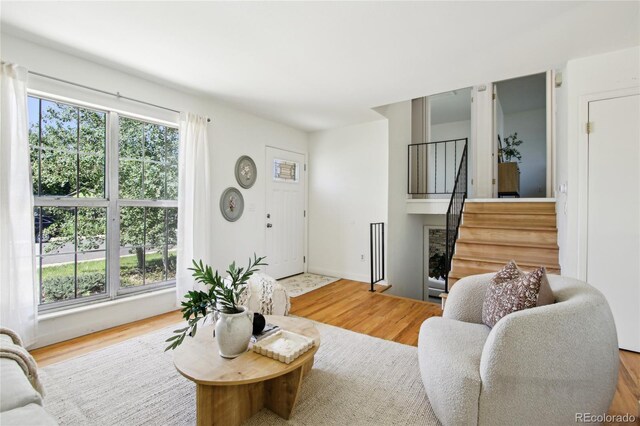 235 Summit Cir, Lafayette, CO 80026 - living area featuring stairway, wood finished floors, and baseboards