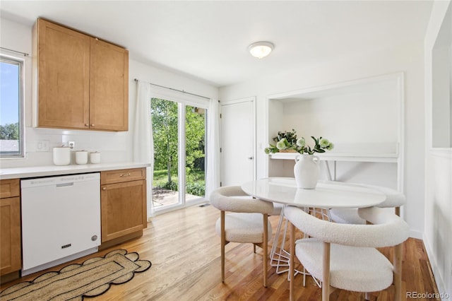 235 Summit Cir, Lafayette, CO 80026 - kitchen featuring white dishwasher, healthy amount of natural light, light wood finished floors, and light countertops