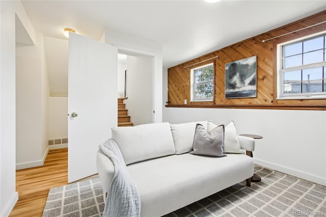 235 Summit Cir, Lafayette, CO 80026 - living room with healthy amount of natural light, baseboards, stairway, and wood walls