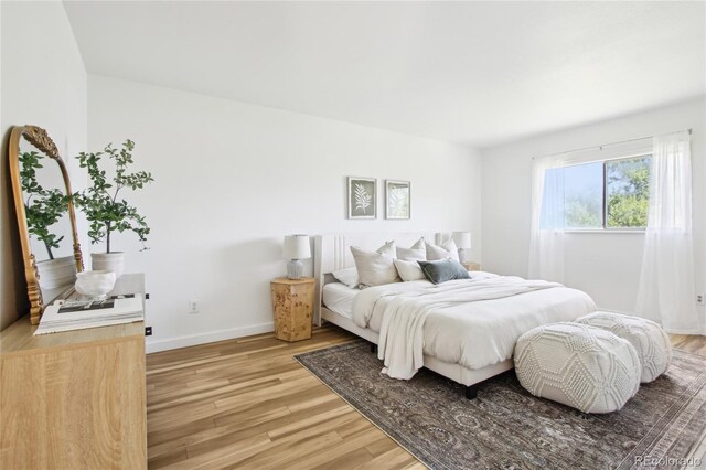 235 Summit Cir, Lafayette, CO 80026 - bedroom featuring light wood-type flooring and baseboards