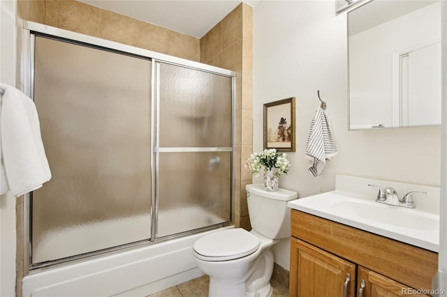 235 Summit Cir, Lafayette, CO 80026 - bathroom featuring bath / shower combo with glass door, toilet, vanity, and tile patterned flooring