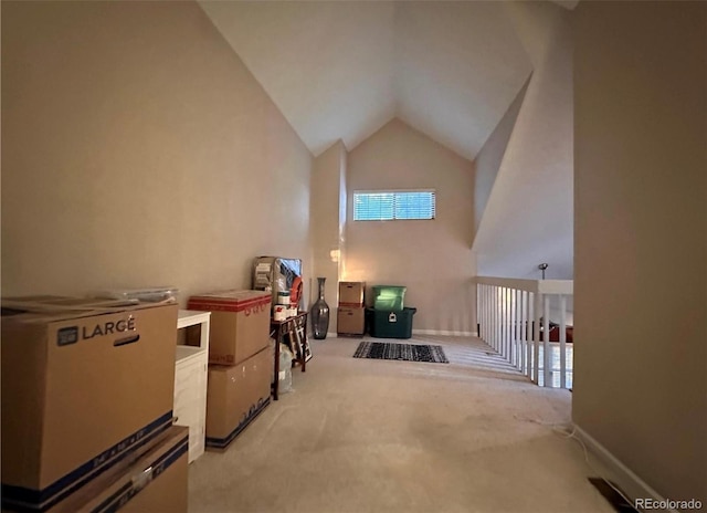 additional living space featuring light carpet and high vaulted ceiling