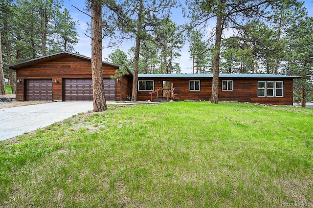 26499 W St, Conifer, CO 80433 - rustic home with a front lawn, concrete driveway, and an attached garage