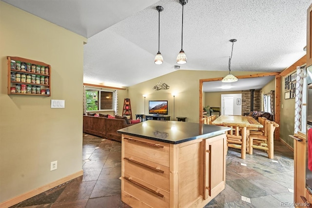26499 W St, Conifer, CO 80433 - kitchen featuring open floor plan, dark countertops, lofted ceiling, light brown cabinets, and a textured ceiling