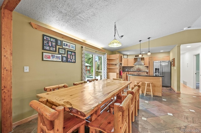 26499 W St, Conifer, CO 80433 - dining space with a textured ceiling, lofted ceiling, and stone tile flooring