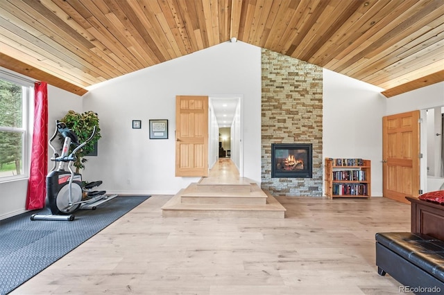 26499 W St, Conifer, CO 80433 - exercise room with vaulted ceiling, a stone fireplace, wood finished floors, and wood ceiling