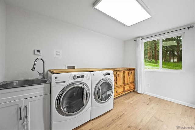 26499 W St, Conifer, CO 80433 - laundry room with cabinet space, separate washer and dryer, and light wood finished floors