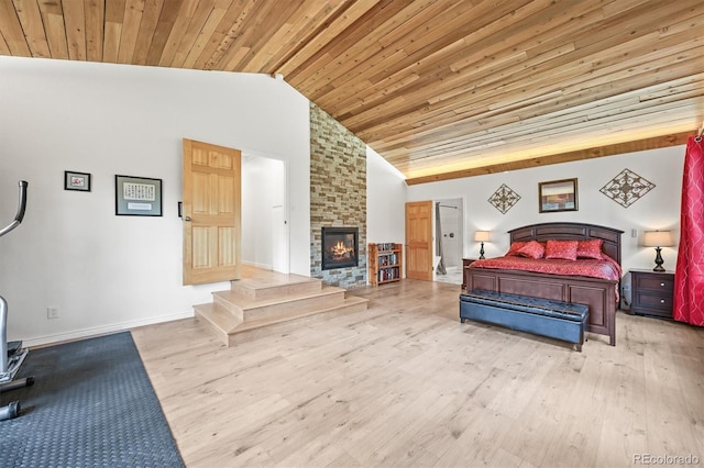 26499 W St, Conifer, CO 80433 - bedroom with wood finished floors, wood ceiling, a brick fireplace, and high vaulted ceiling