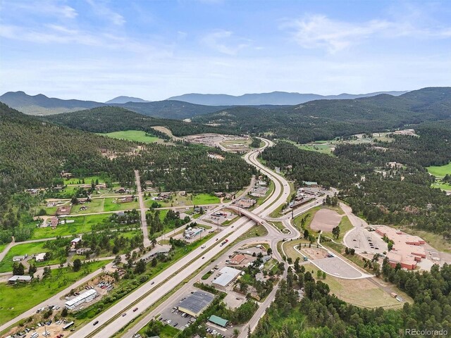 26499 W St, Conifer, CO 80433 - aerial overview of property's location featuring a mountain backdrop